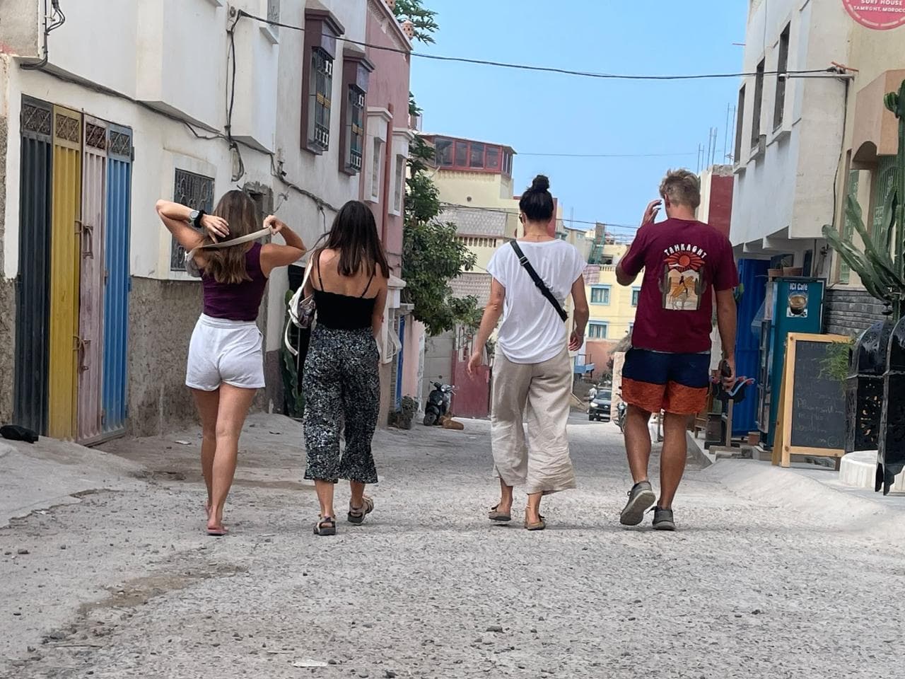 Guests strolling the colorful streets of Tamraght on discovery day