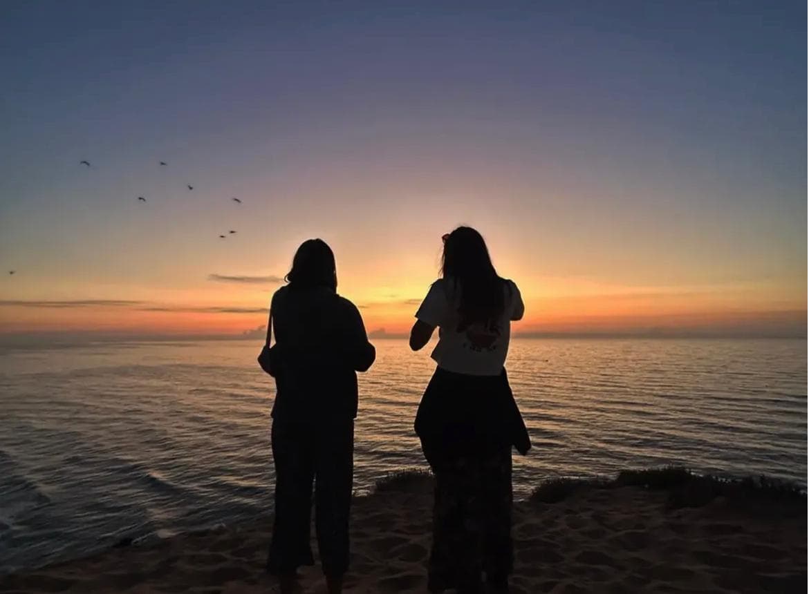 Two friends watching the sun melt into the Atlantic — Couple week